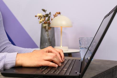 Hands on the computer keyboard.