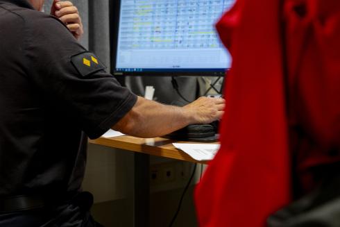 A rescue worker works on a computer.